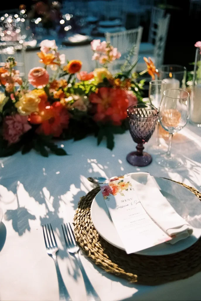 Wedding table with flowers and a handwritten menu at a wedding in Sotogrande, shot on film
